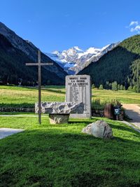 Built structure on field by mountain against sky