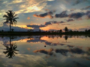 Scenic view of lake against sky during sunset