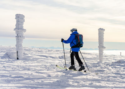 Full length of man standing on snow covered land