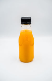 Close-up of yellow bottle against white background