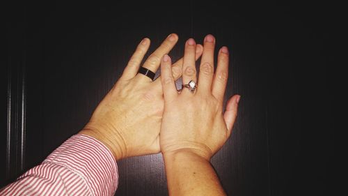 Close-up of woman hand on finger against black background