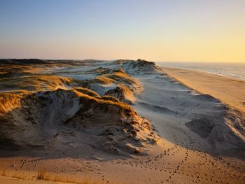 Scenic view of sea against clear sky during sunset