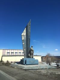 Statue against blue sky