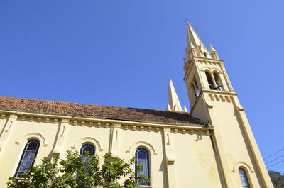 Low angle view of church against blue sky