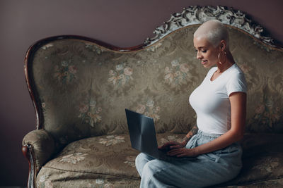 Young woman using mobile phone at home