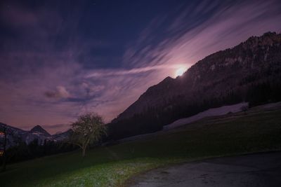 Scenic view of mountains against sky at night