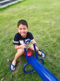 Portrait of smiling boy playing in park