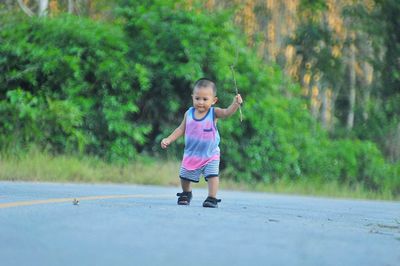 Portrait of boy standing on road