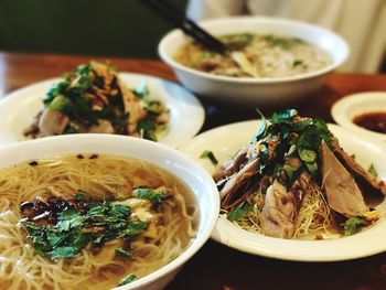 Close-up of noodle soups in bowls served on table