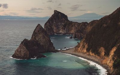 Scenic view of sea and rock formation against sky