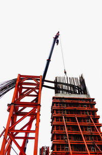 Low angle view of crane against clear sky