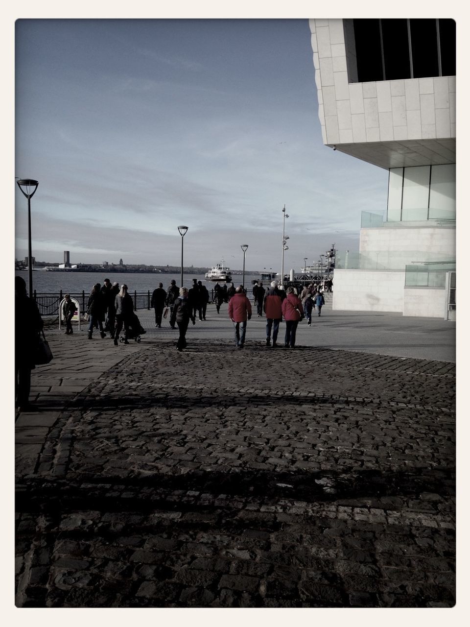 large group of people, transfer print, sky, men, person, architecture, auto post production filter, building exterior, built structure, lifestyles, street, transportation, walking, city, city life, cloud - sky, leisure activity, mixed age range, road