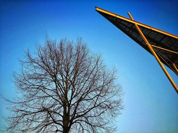 Low angle view of bare tree against clear blue sky