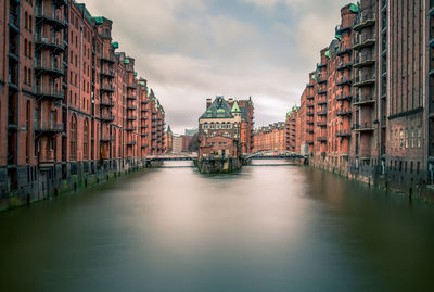 Canal amidst buildings in city