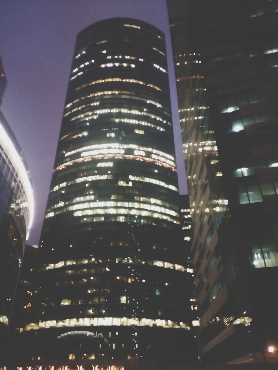 LOW ANGLE VIEW OF ILLUMINATED BUILDINGS AGAINST SKY