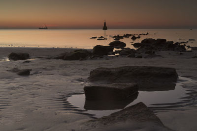 Scenic view of sea against sky at sunset