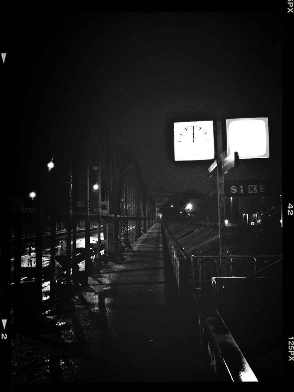 illuminated, built structure, architecture, transportation, night, railing, text, clear sky, the way forward, building exterior, western script, railroad station, communication, public transportation, information sign, city, railroad station platform, rail transportation, sign, indoors