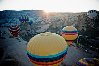 Multi colored hot air balloon flying against sky