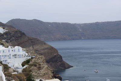 Scenic view of sea and mountain against sky