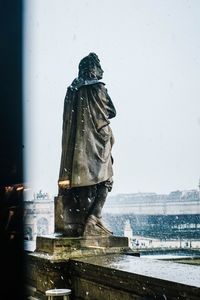 Statue against sky in city