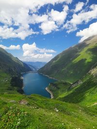 Scenic view of lake and mountains against sky