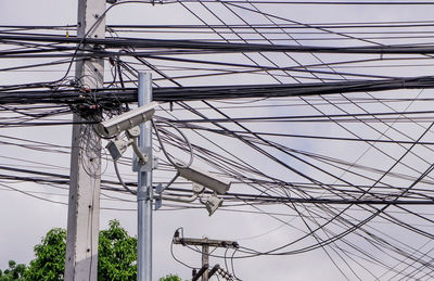 Low angle view of electricity pylon against sky