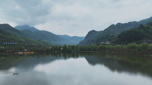 Scenic view of lake and mountains against sky