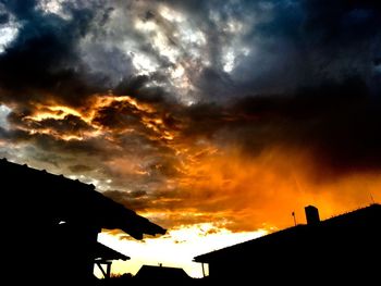 Low angle view of silhouette buildings against sky during sunset