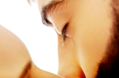 Close-up portrait of a woman over white background