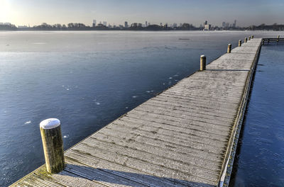 Pier over lake against sky