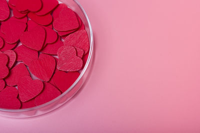 High angle view of heart shape on pink table