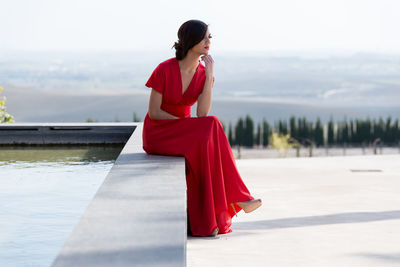 Woman standing with red umbrella