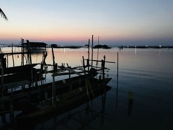 Sailboats in marina at sunset