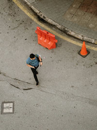 High angle view of woman walking on road