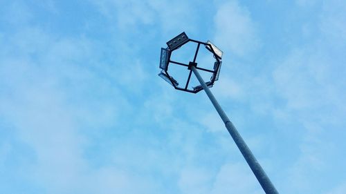 Low angle view of floodlight against blue sky