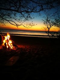 Scenic view of beach against sky during sunset