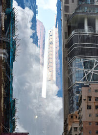 Low angle view of buildings in city against sky