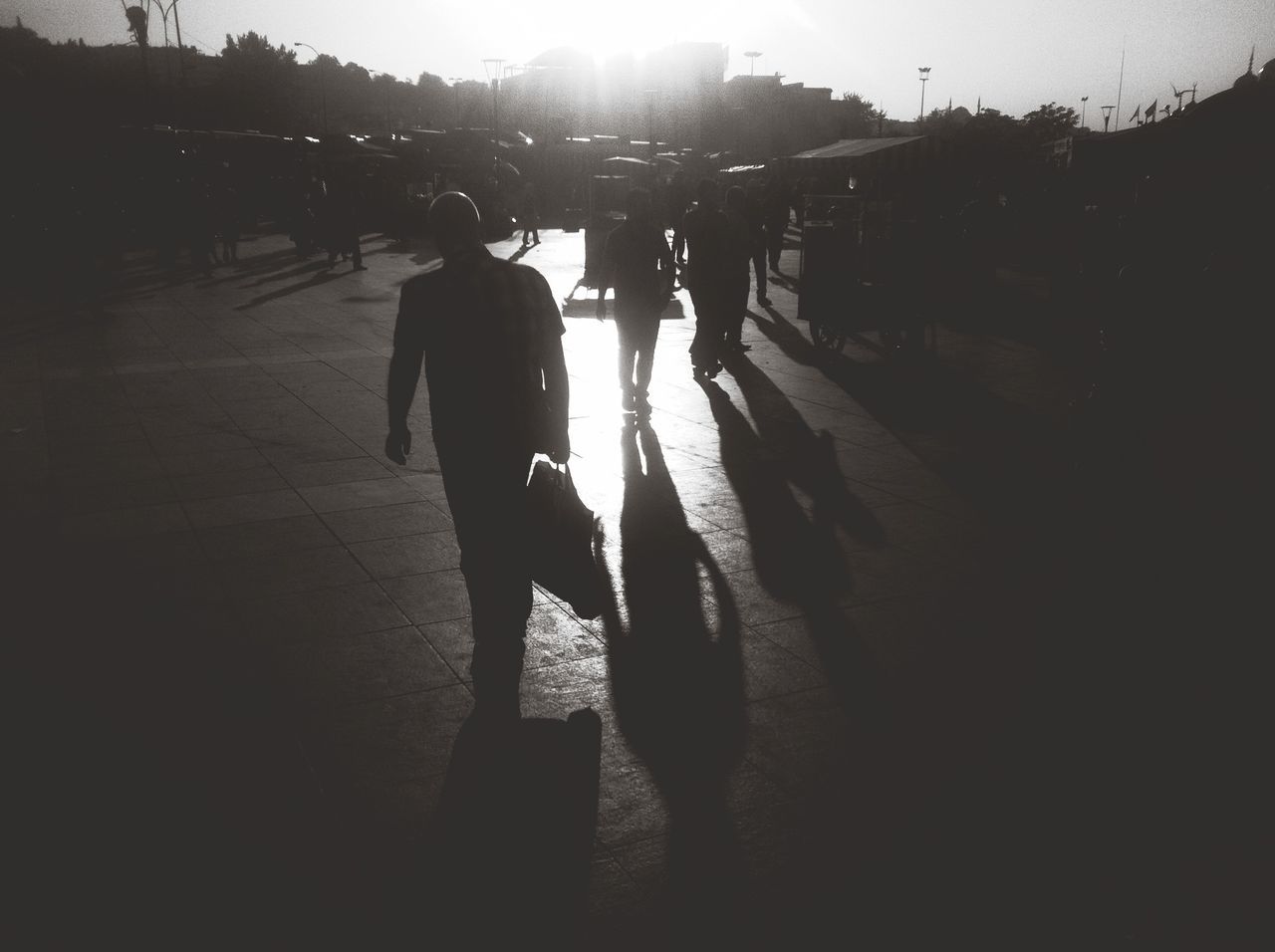 lifestyles, leisure activity, full length, silhouette, shadow, walking, sunlight, men, street, togetherness, boys, person, road, bonding, childhood, outdoors, standing