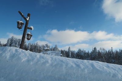 Low angle view of snow covered land against sky