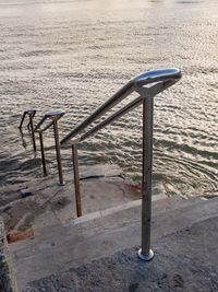 High angle view of empty chairs on beach