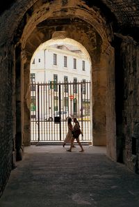 Man riding horse in corridor