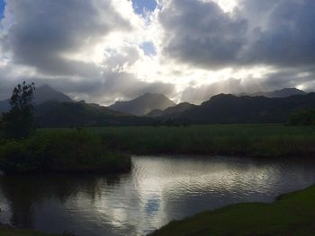 Scenic view of lake and mountains against sky