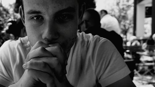 Close-up portrait of young man at cafe