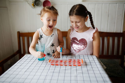 Portrait of cute girl drawing on table