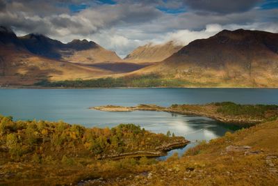 Scenic view of lake and mountains against sky