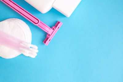 High angle view of hygiene products against blue background