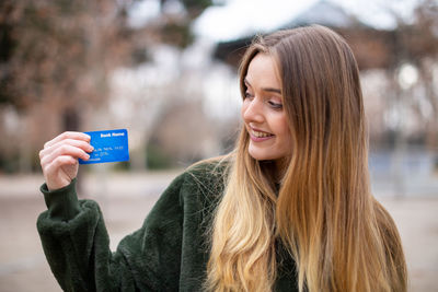 Portrait of young woman using smart phone outdoors