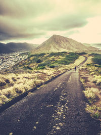 Empty road along countryside landscape