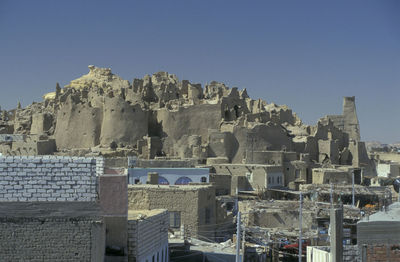 Buildings in city against clear sky