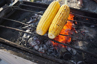 High angle view of corns on barbecue grill